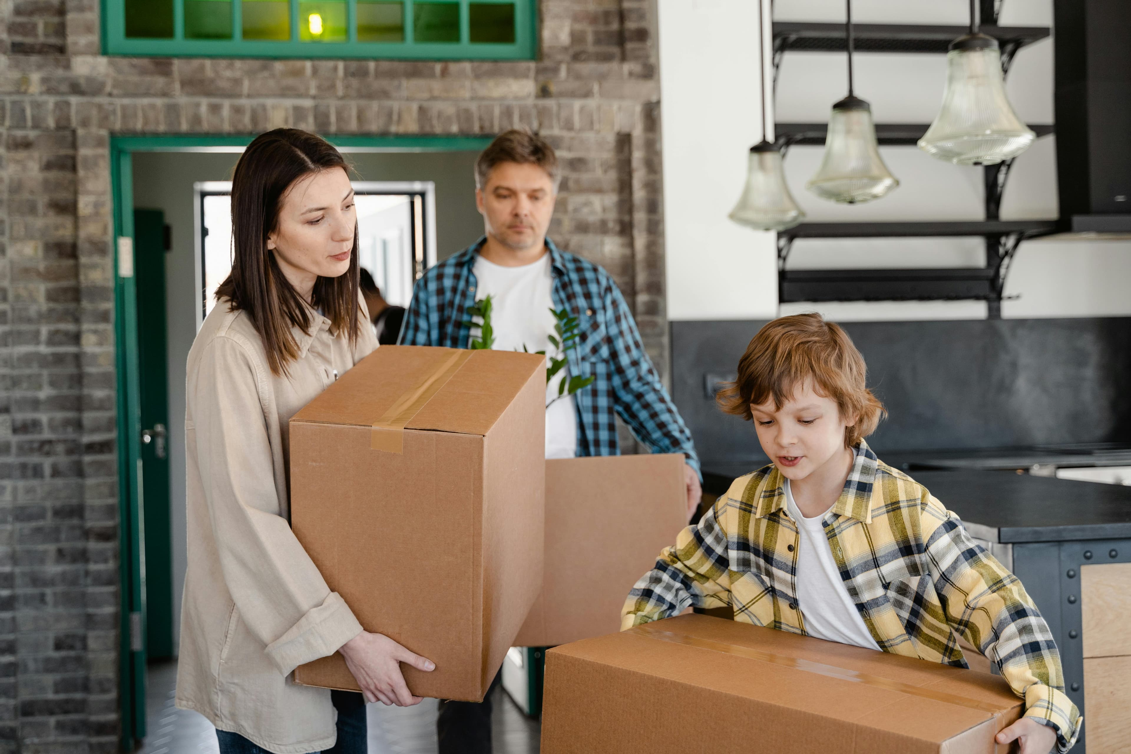 Family moving boxes into a completed home